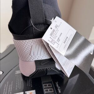 Nike Women’s Black and Light Pink Slip-On Athletic Shoe